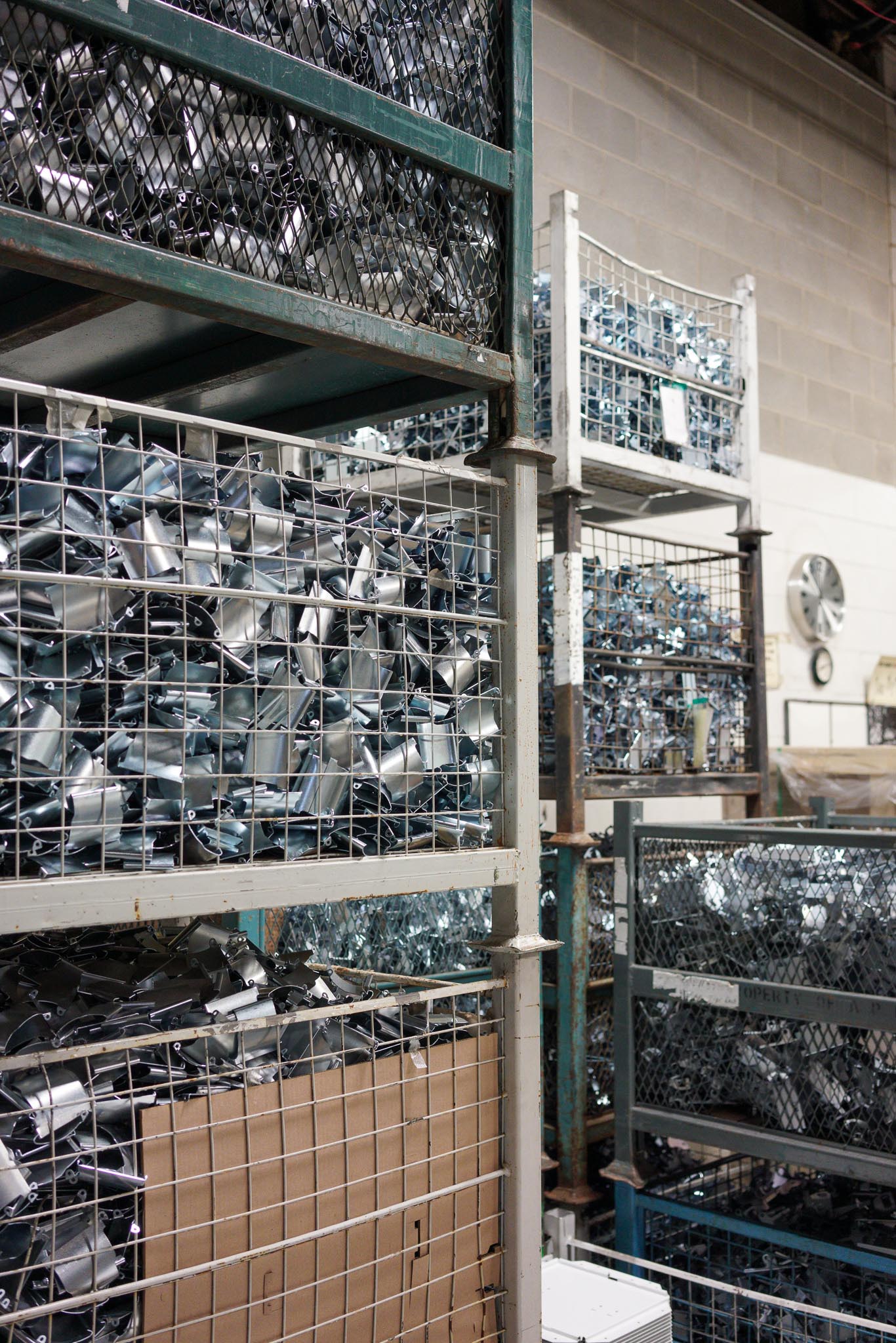 Custom metal stamped part inventory in warehouse.